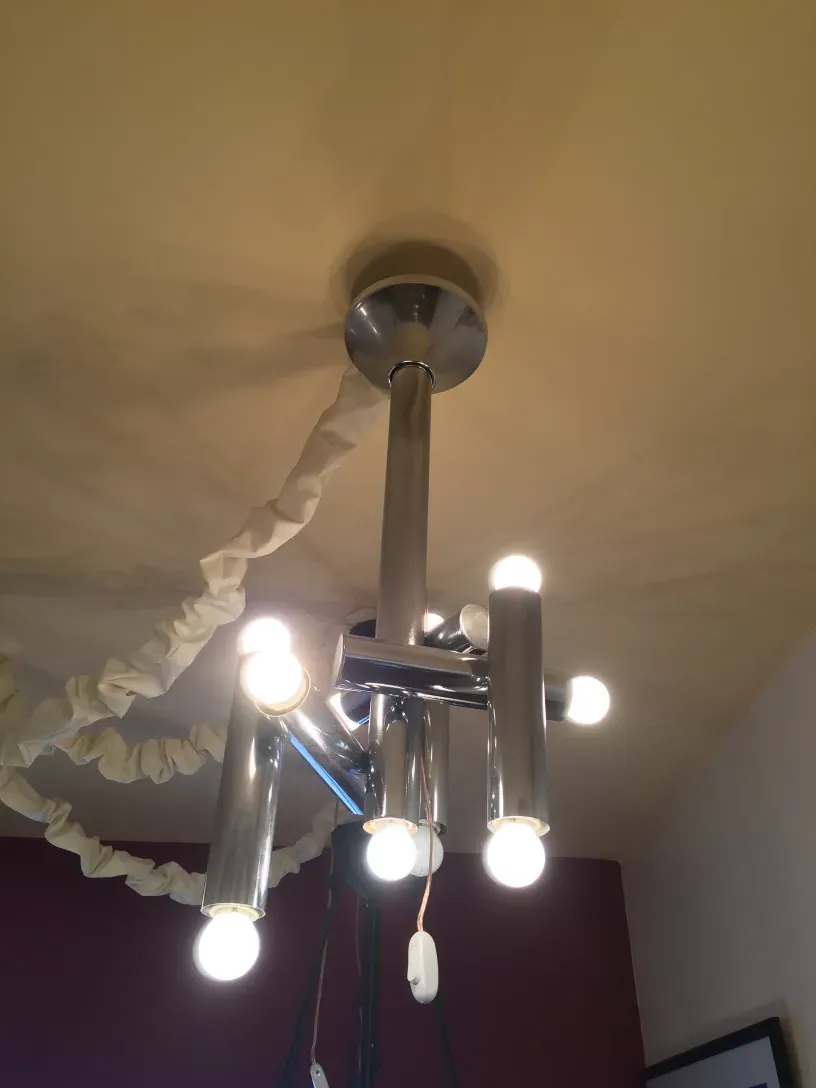 Antique hanging lamp featuring multiple protruding lights.