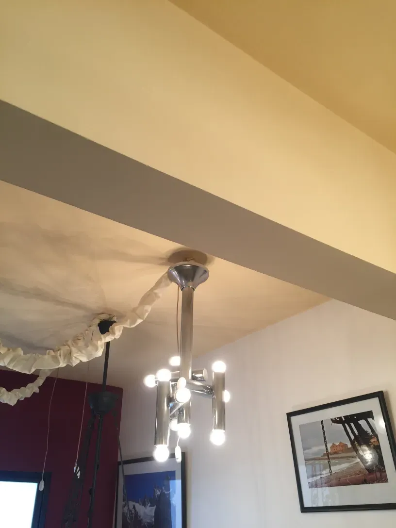 Antique hanging lamp with multiple bulbs in a modern setting.