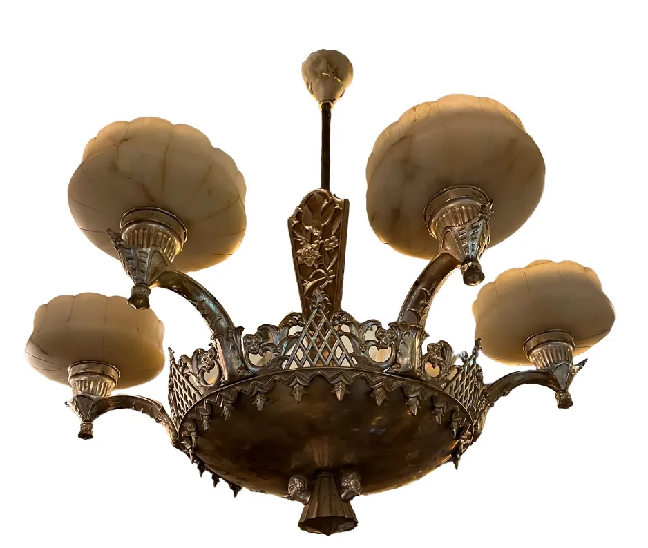 Antique hanging lamp featuring ornate design and glass globes