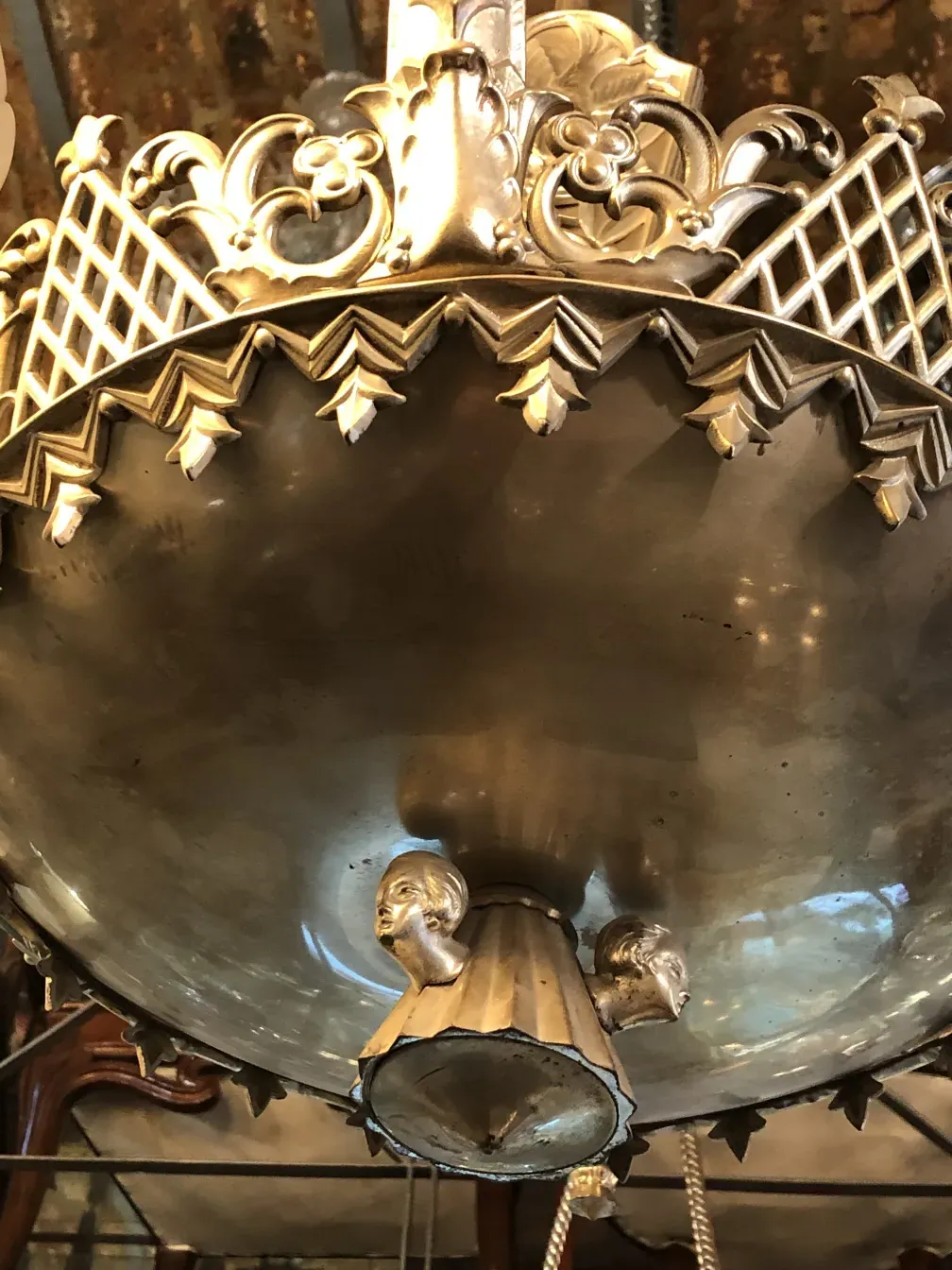 Antique hanging lamp featuring an ornate decorative design.