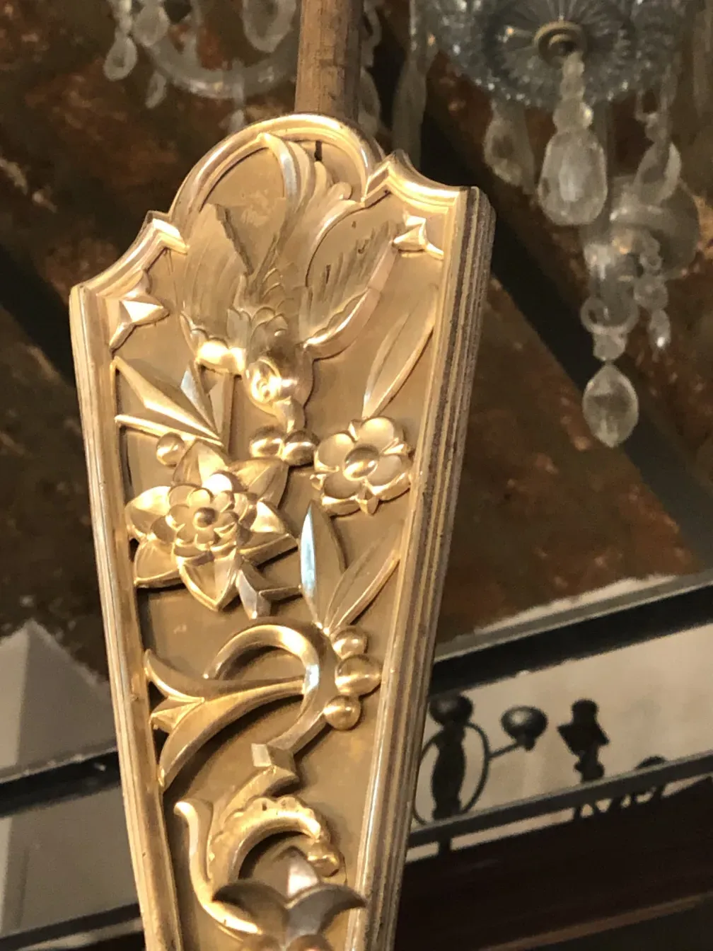 Antique hanging lamp with intricate floral details, warm ambiance.