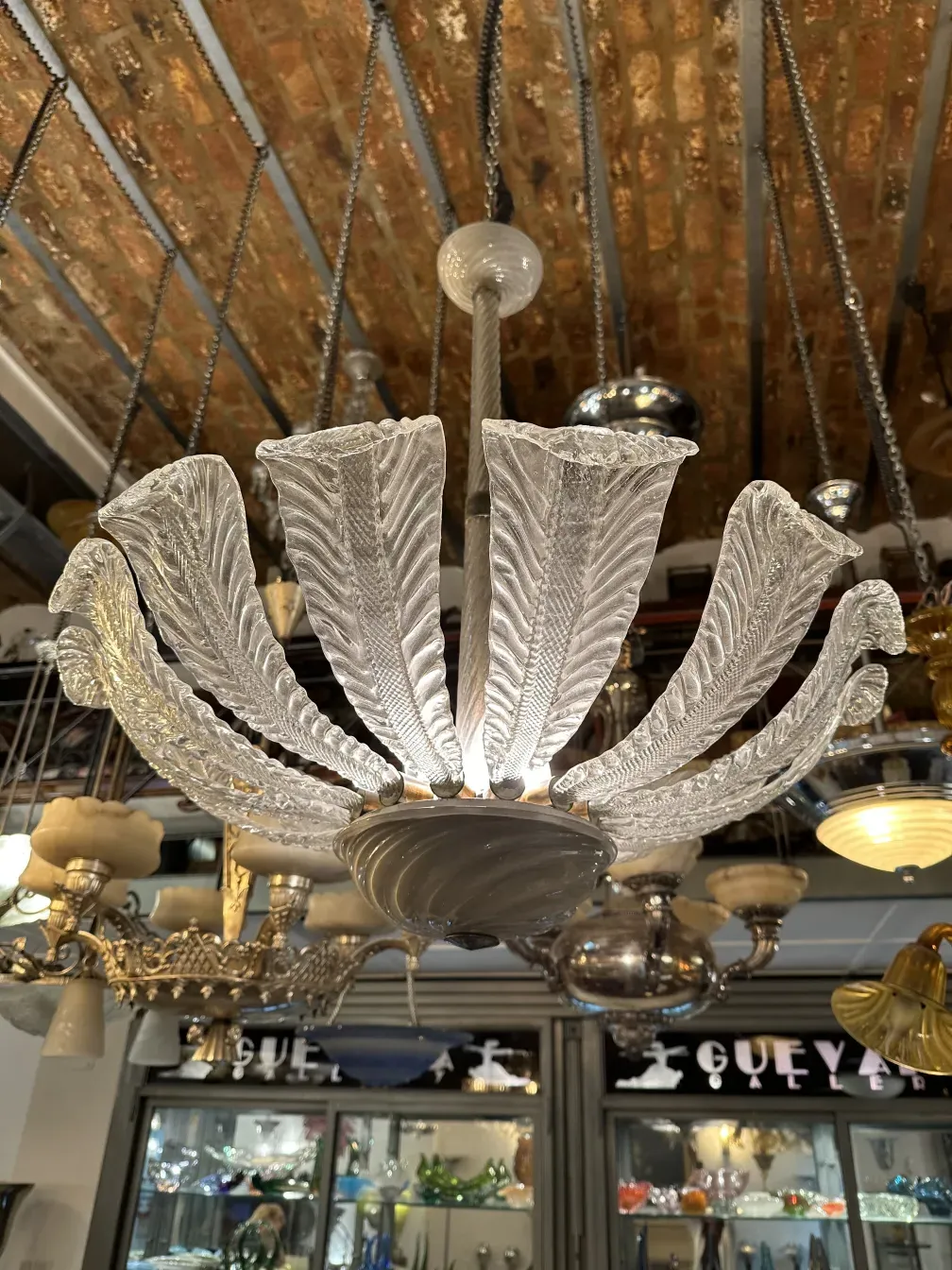 antique hanging lamp with elegant detailed design, paolo venini style, illuminating the surroundings