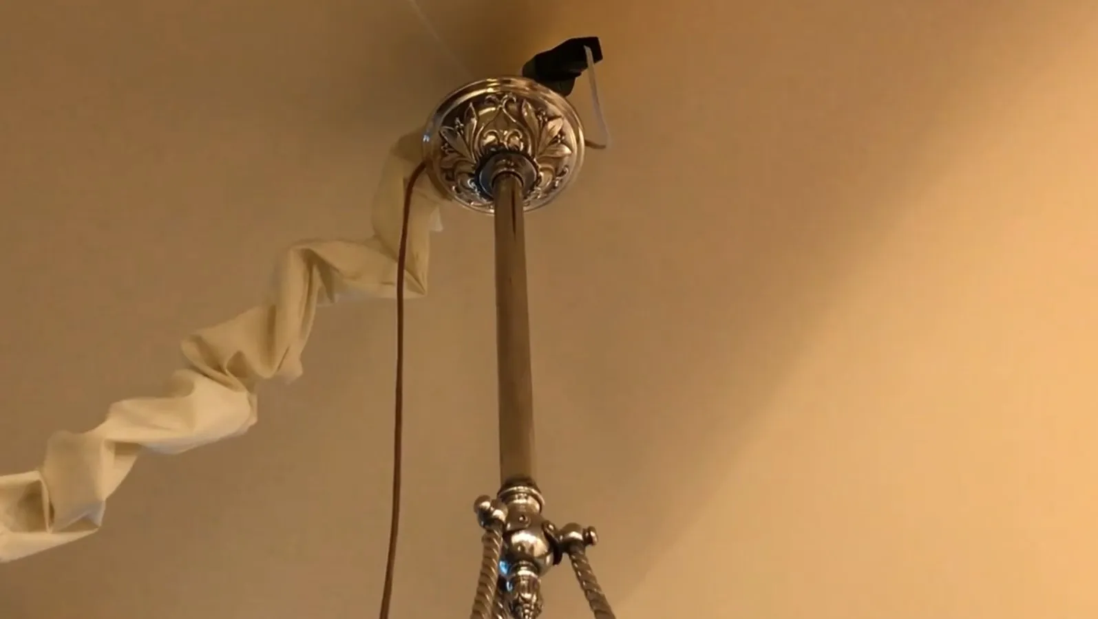 Antique hanging lamp with elegant finishes in a cozy setting.