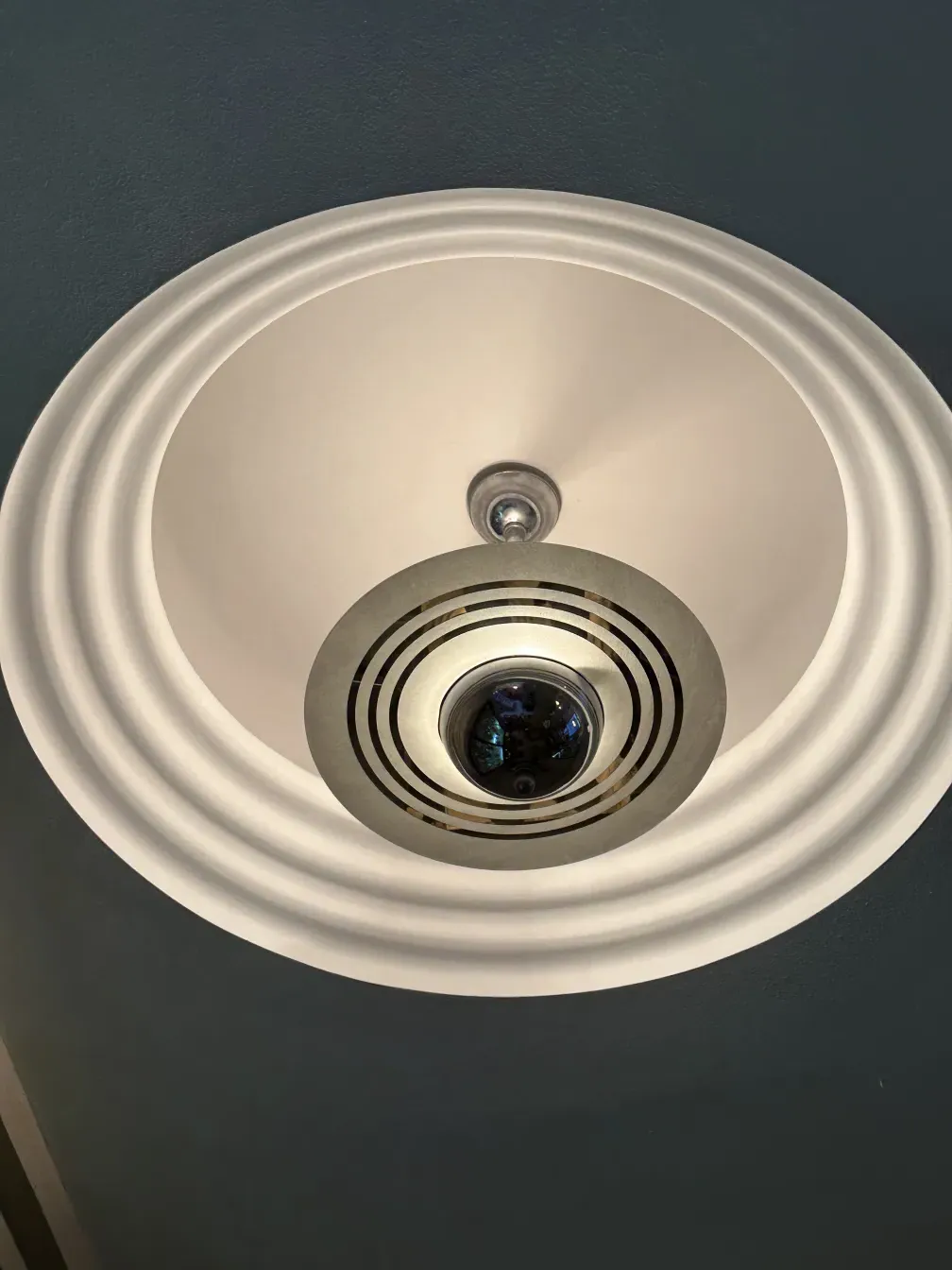 Antique hanging lamp in a modern setting with subtle details.