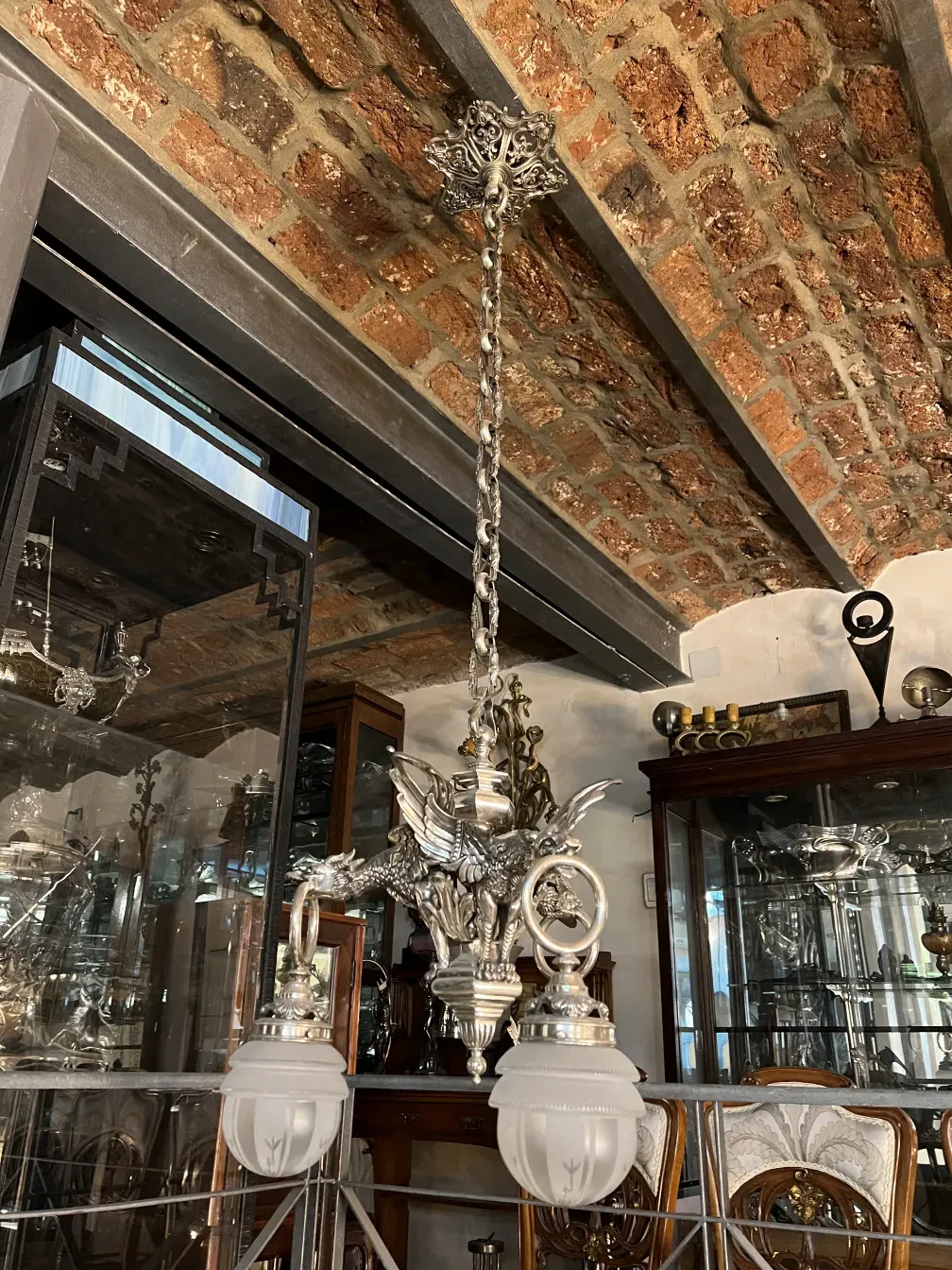 Antique hanging lamp with decorative bases in an elegant setting.