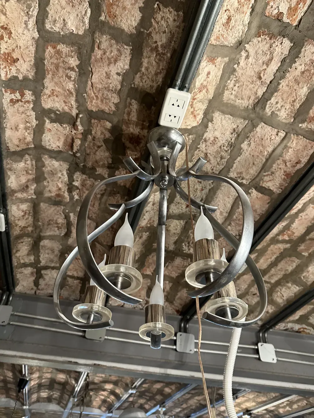 Antique hanging lamp with elegant design in a rustic setting.