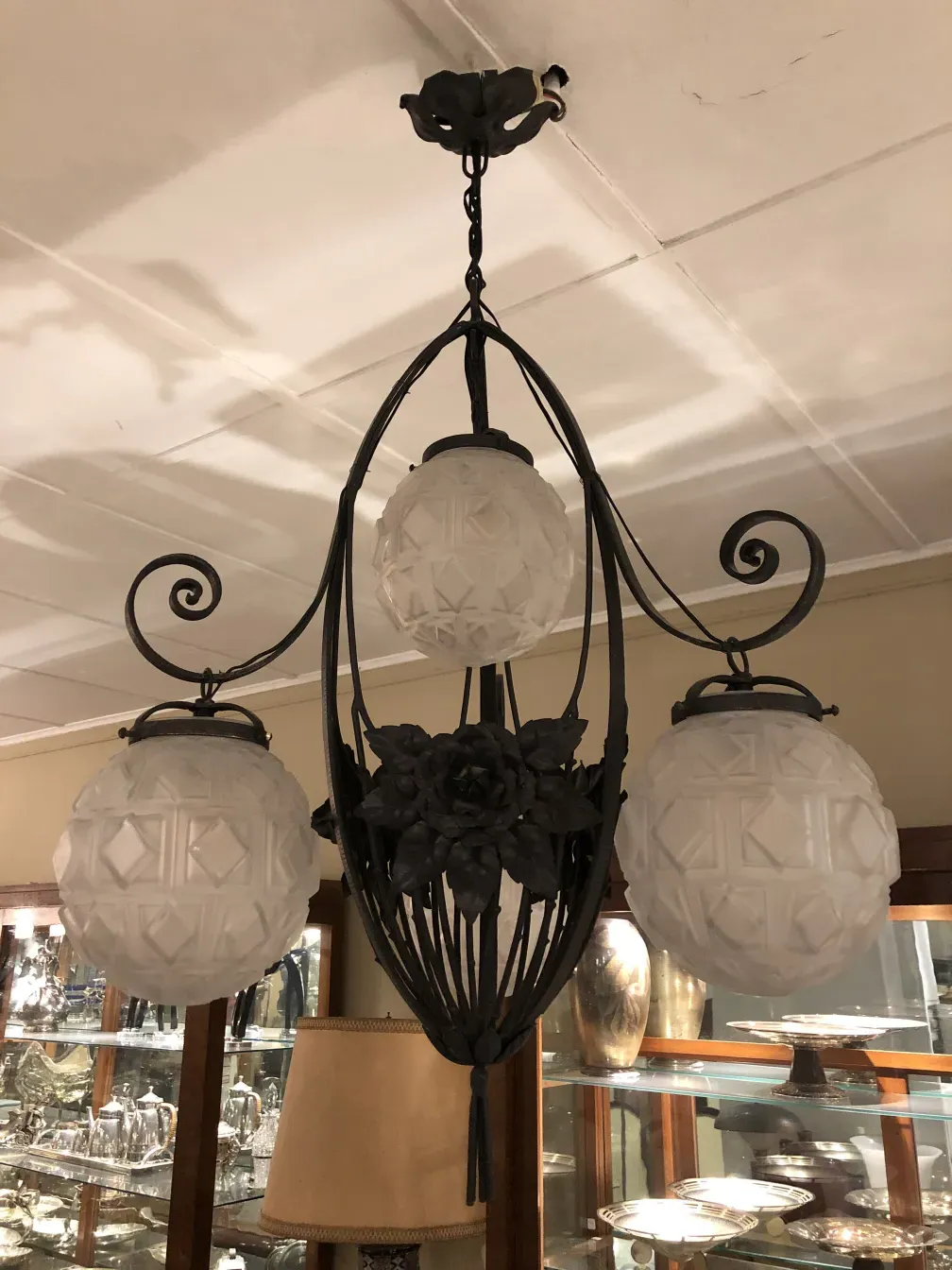Antique hanging lamp featuring decorative glass spheres