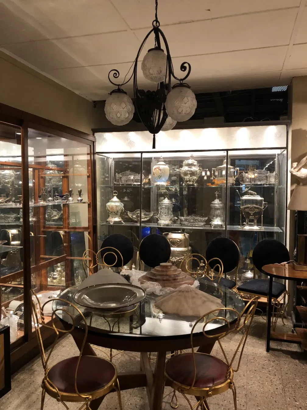 Antique hanging lamp made of glass with six globes, elegant setting.