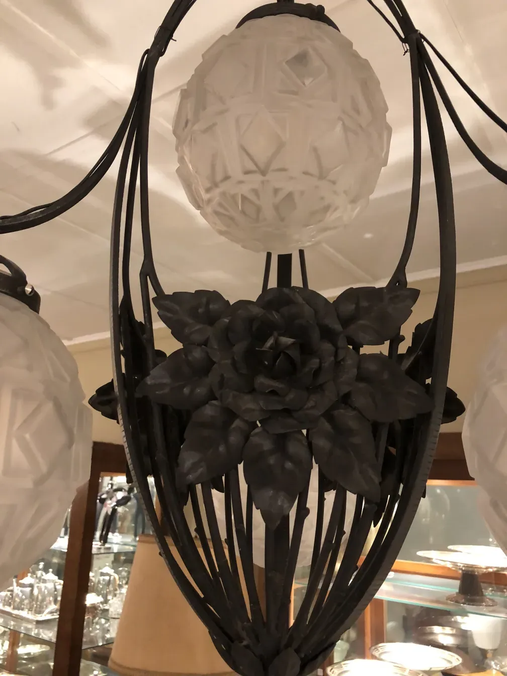 Antique hanging lamp with rose details and elegant finish.