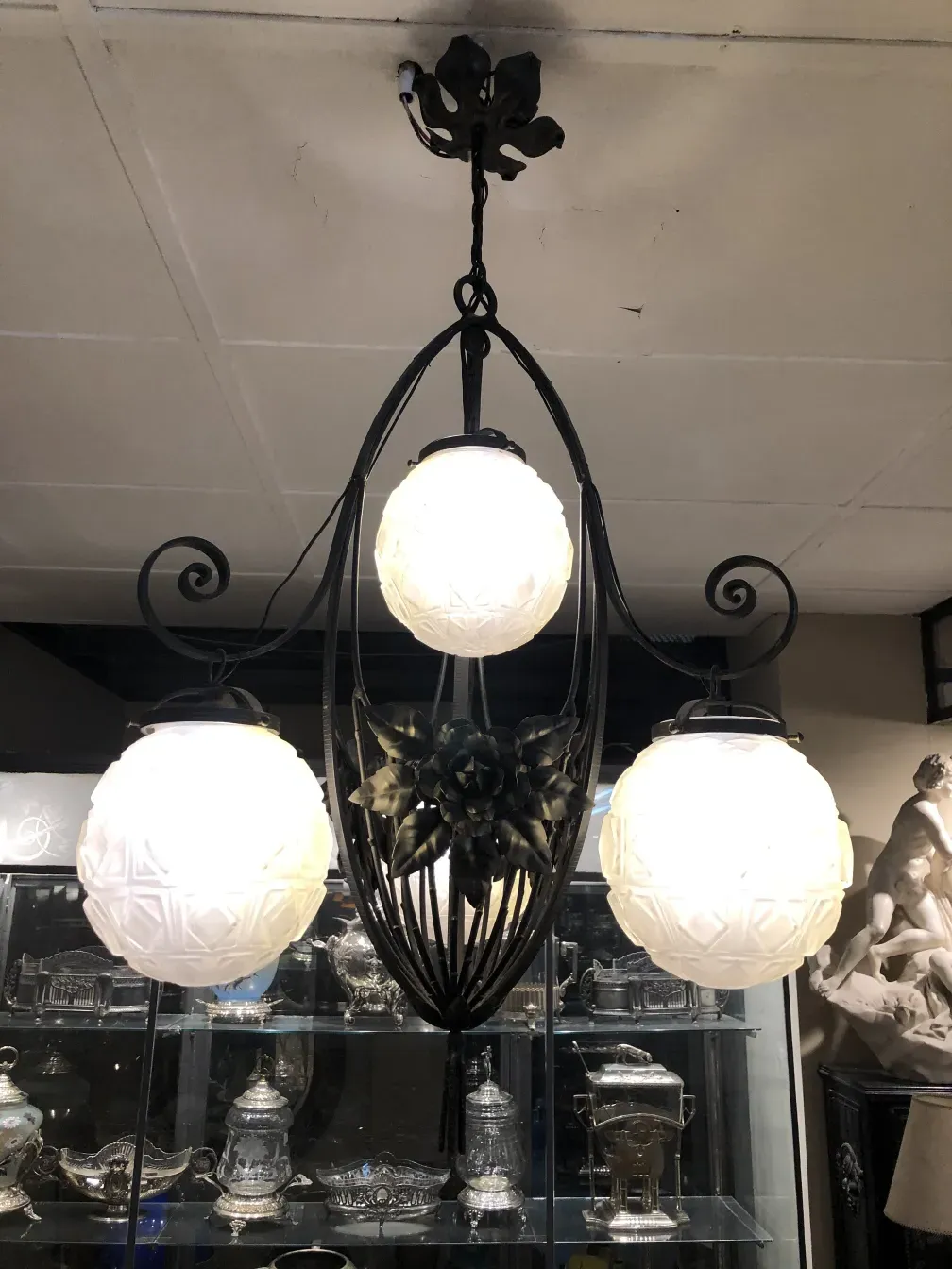 antique hanging lamp with three white spheres in an elegant setting