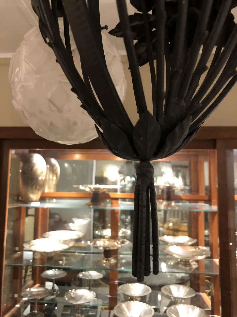 Antique hanging lamp with a unique design in a cozy setting.