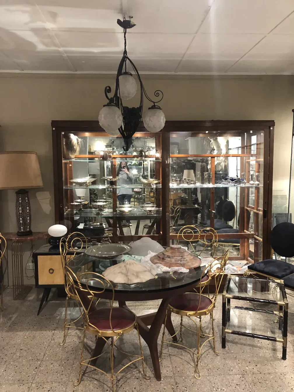 Antique hanging lamp with three white globes, elegant setting.