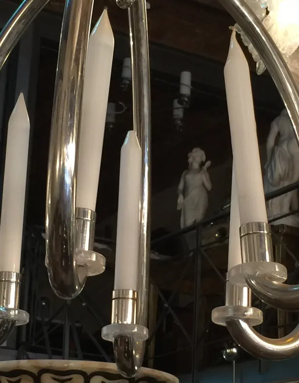 Antique hanging lamp featuring white lights and elegant design.