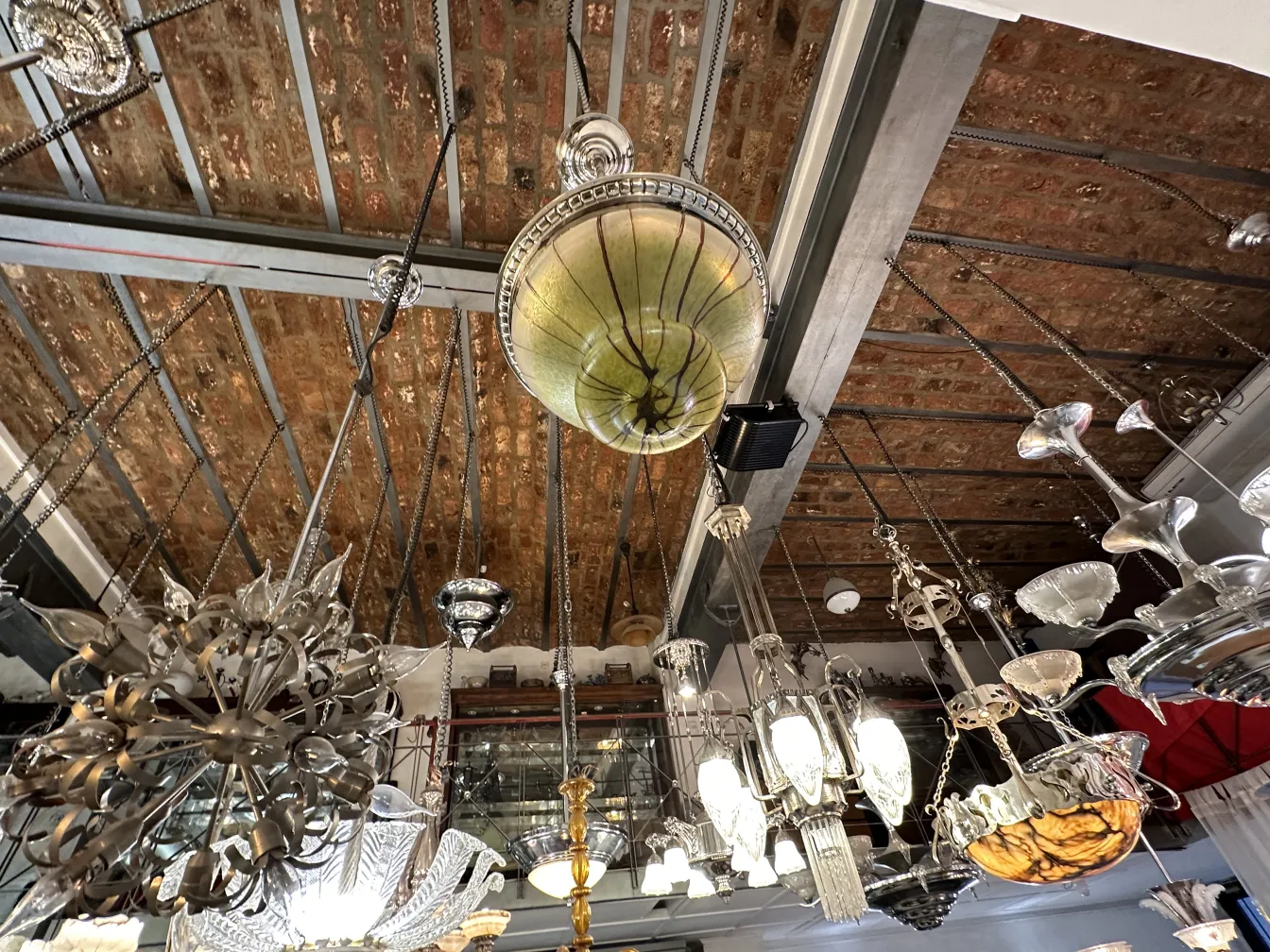 Antique hanging lamp with unique design and decorative details, set in a bright shop.