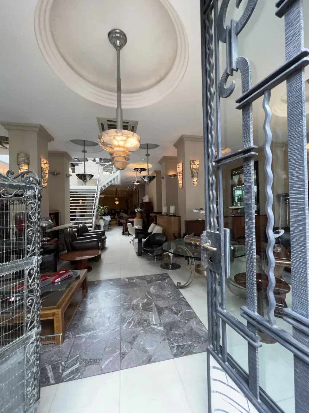 Antique hanging lamp illuminating an elegant living room with furniture