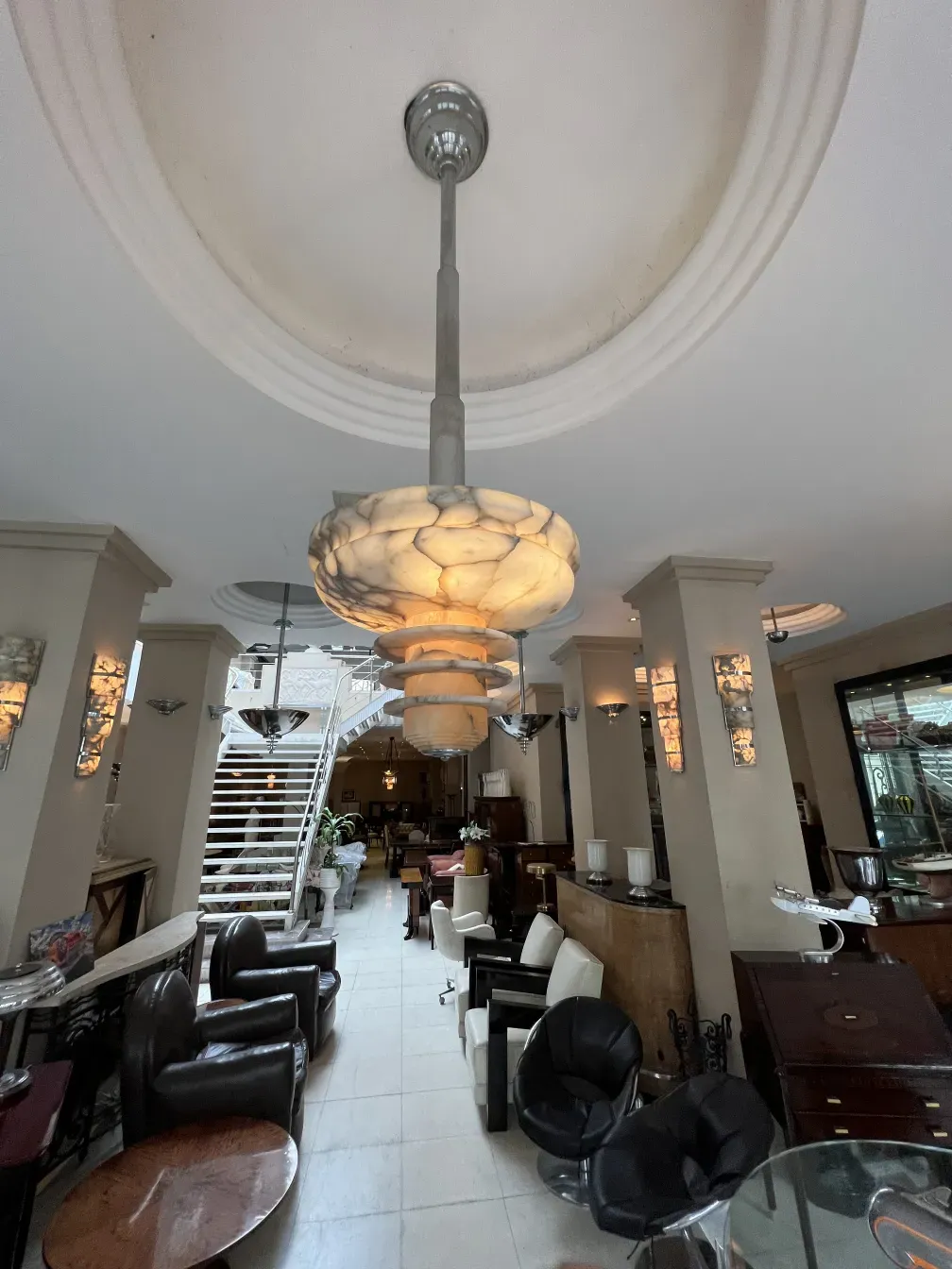 Antique alabaster hanging lamp illuminating a living room.
