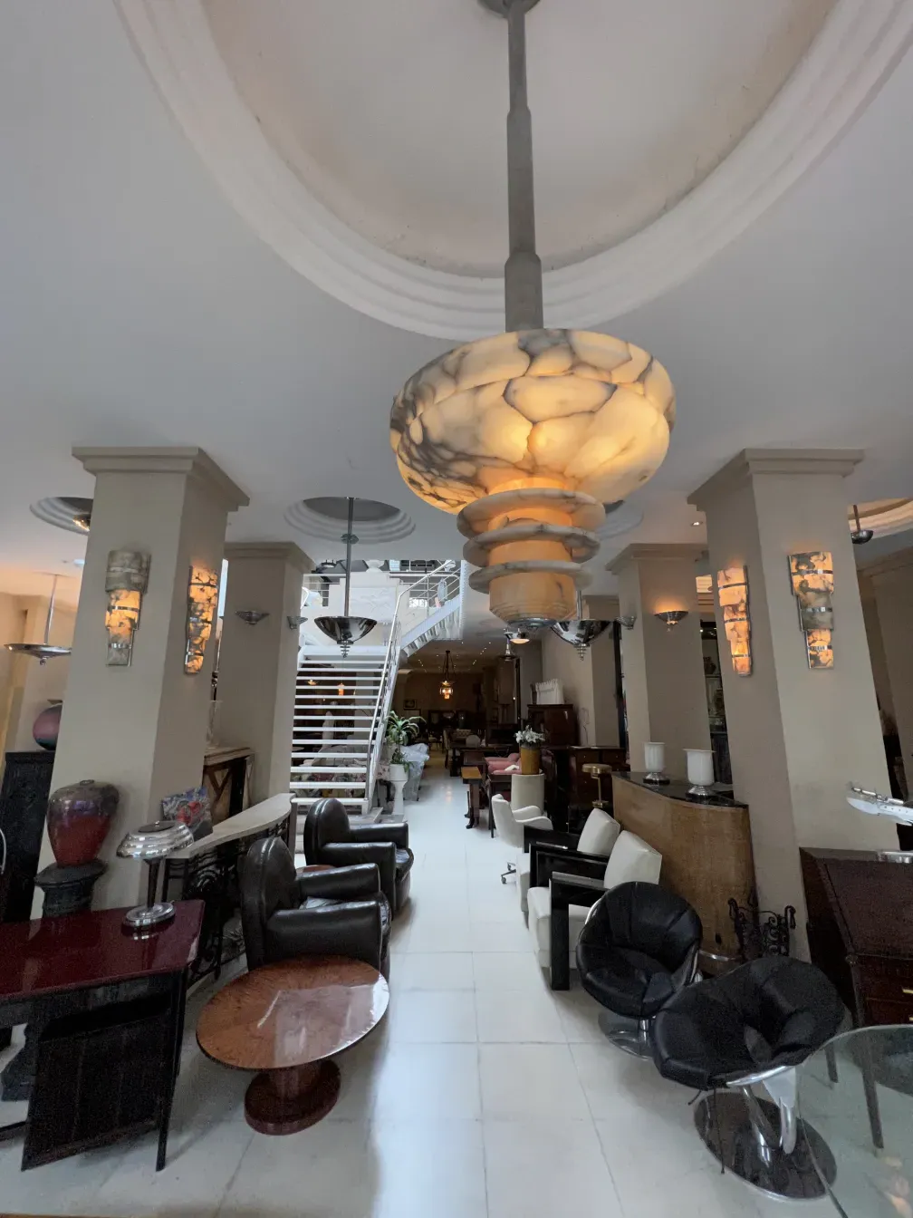 Elegant hanging lamp with intricate details, set in a modern living room