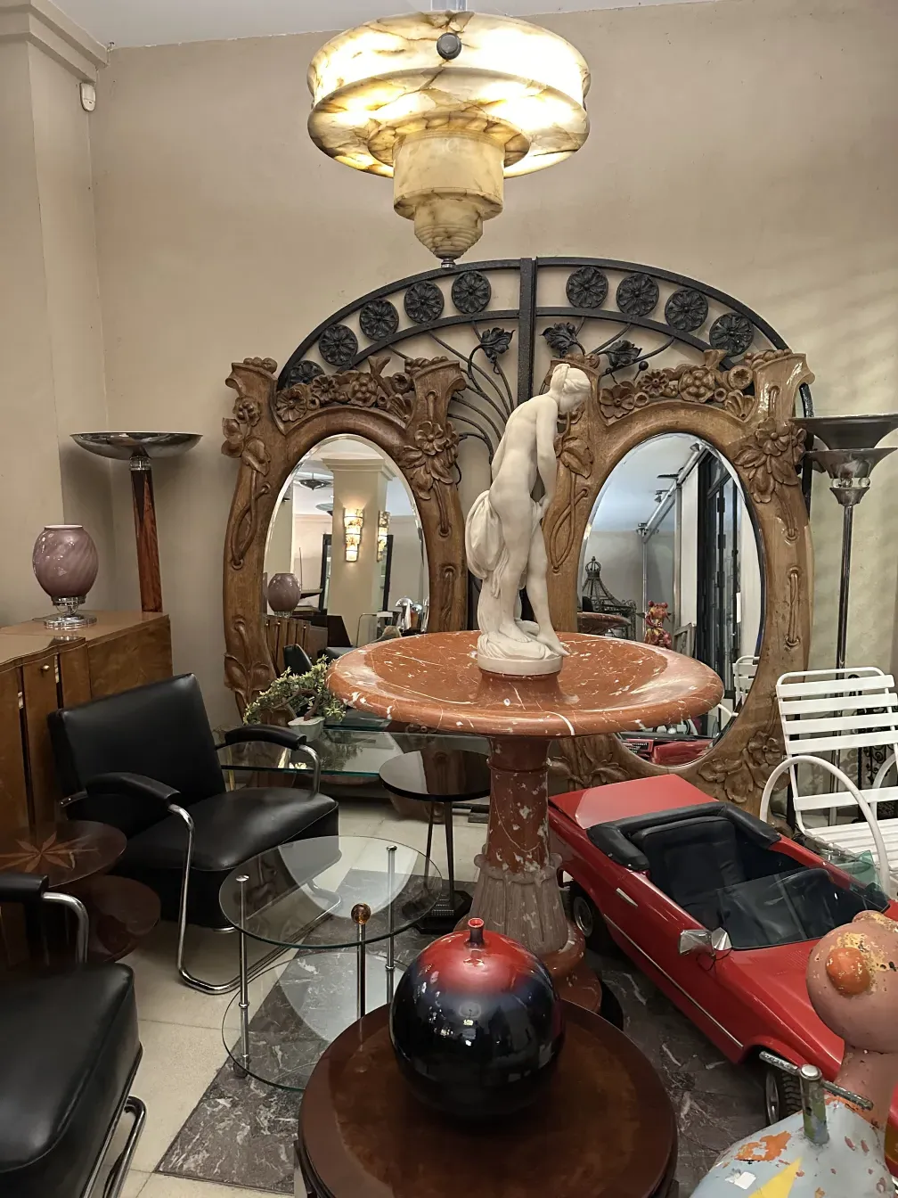 Antique hanging lamp illuminating an elegant space with vintage furniture.