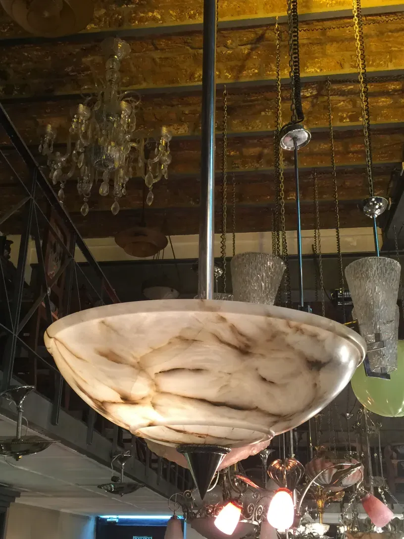 Antique hanging lamp with an elegant design, in a cozy setting with other decorative objects.