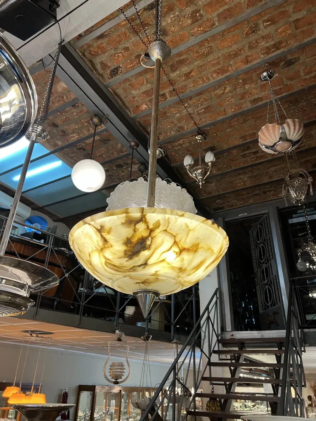 Elegant antique hanging lamp with decorative details in a modern setting.