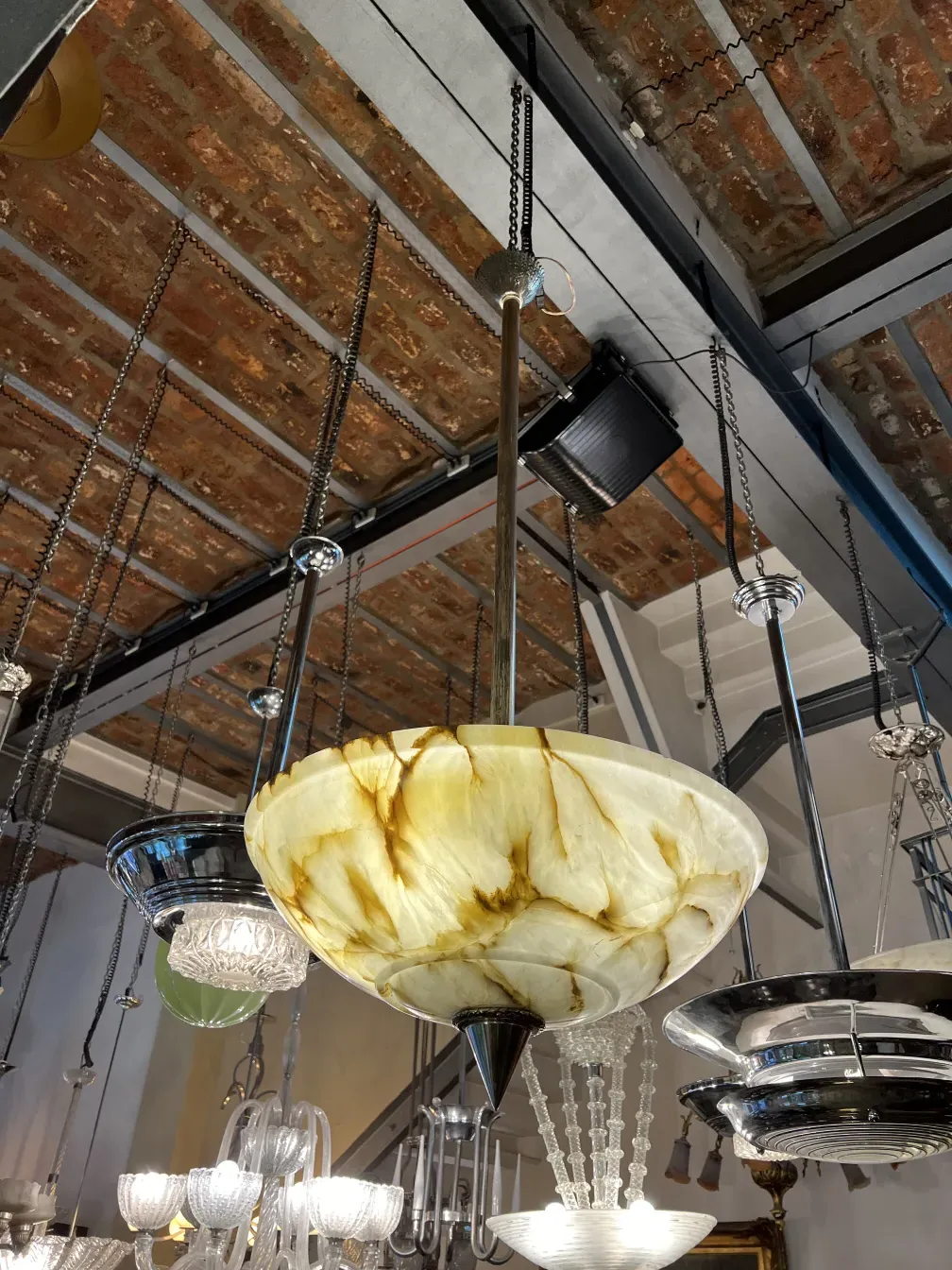 Antique hanging lamp with yellow glass in an elegant setting.