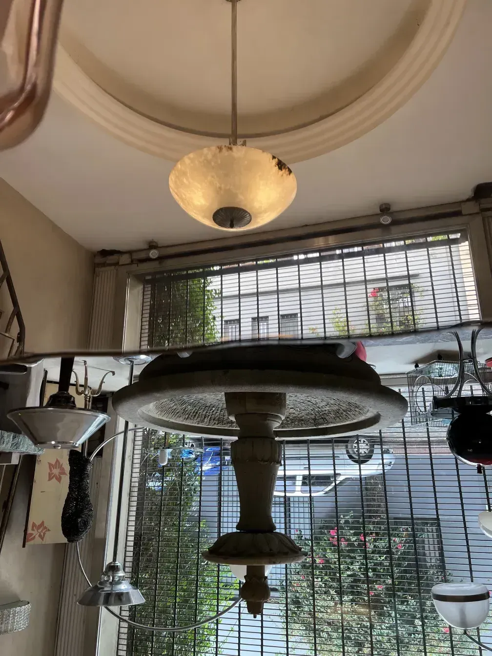 Antique hanging lamp with elegant design, seen in a cozy environment.