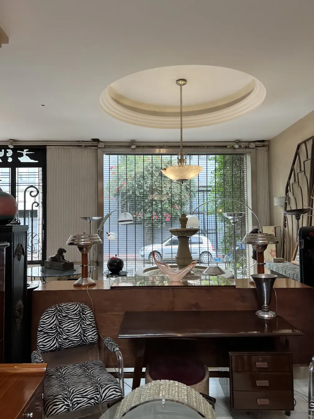 Antique hanging lamp in a room with modern furniture.