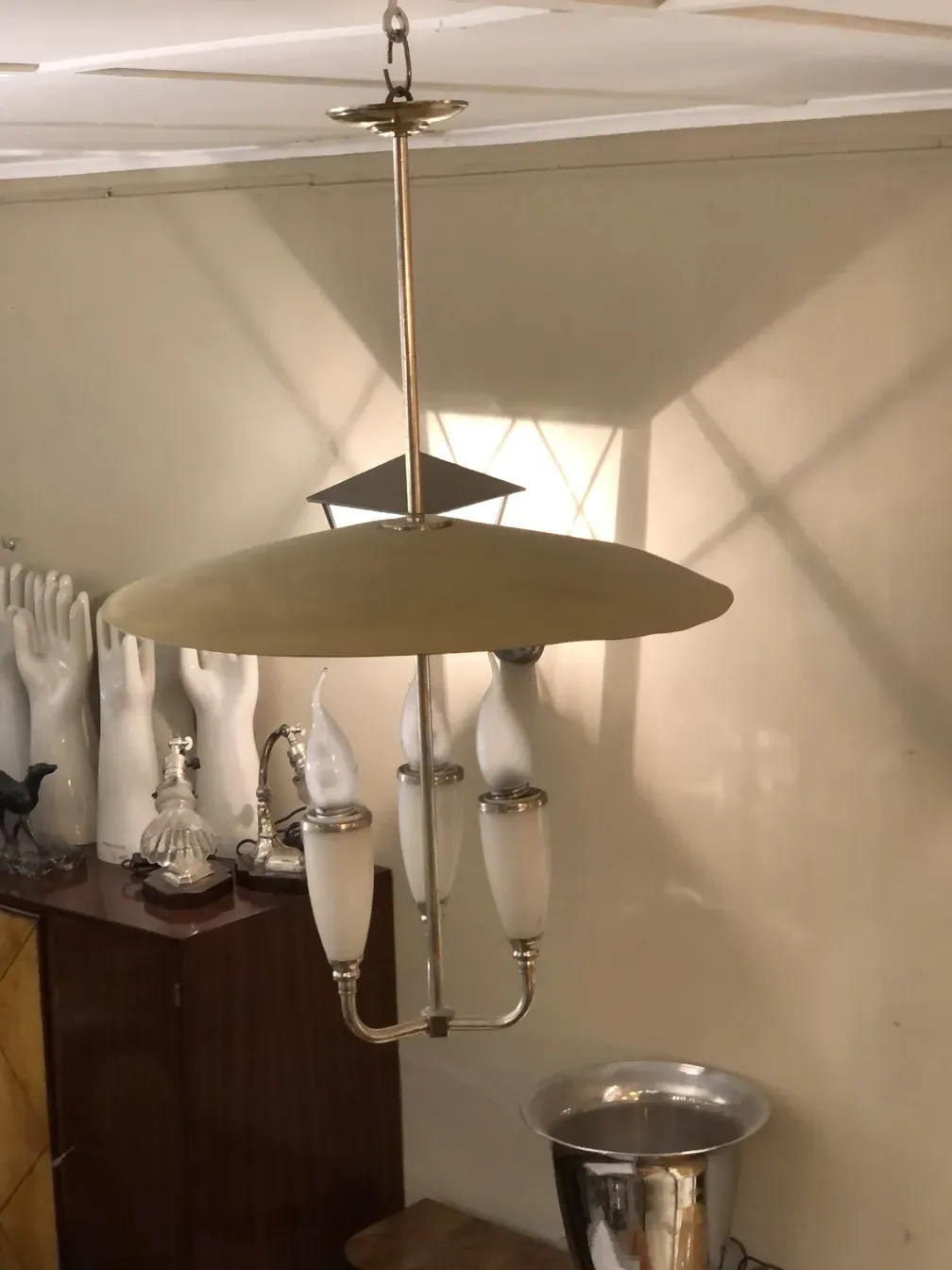 Antique hanging lamp with soft light and metallic details, in an elegant setting