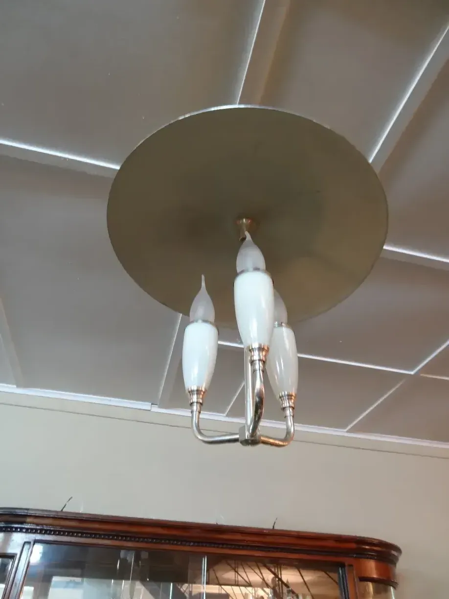 Antique hanging lamp with bright metal arms and white tulips. Perfect for decor.