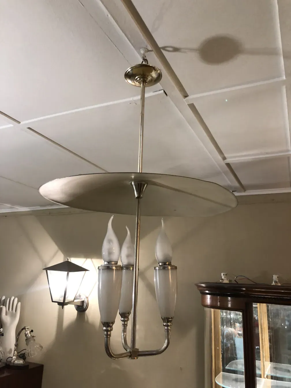 Antique hanging lamp with three white lights, elegant design.