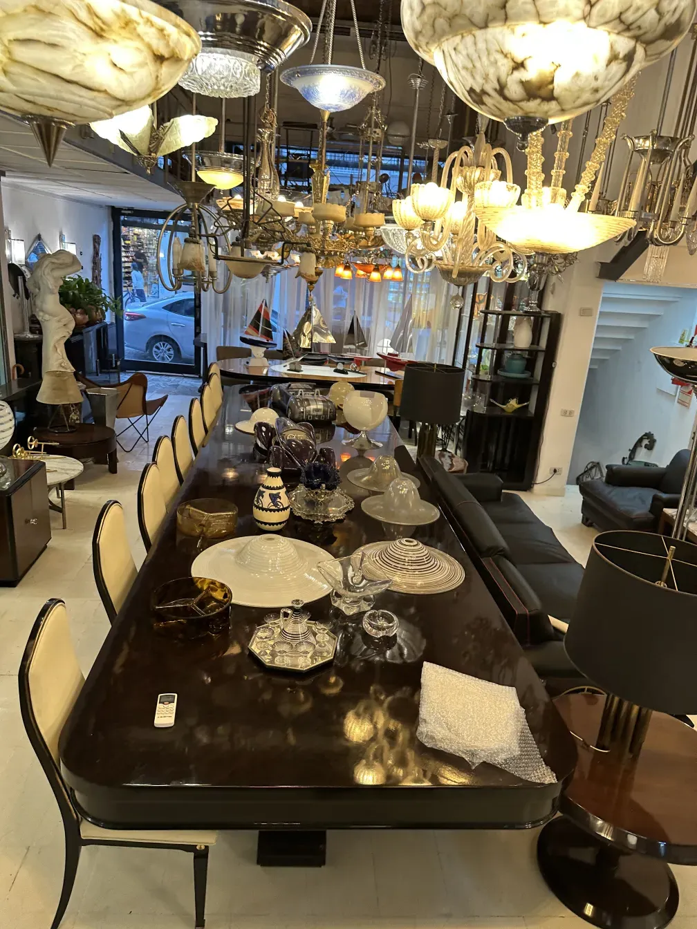 Antique glass hanging lamp illuminating an elegantly decorated table.