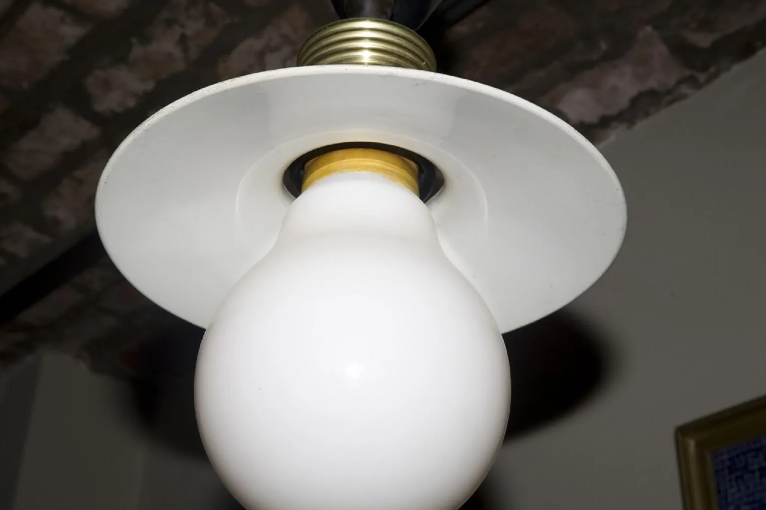 Antique hanging lamp with a white shade.