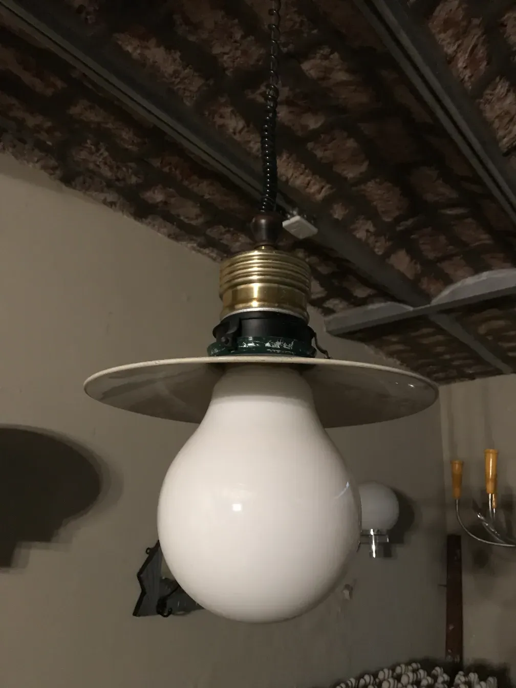 Antique hanging lamp with a white bulb.