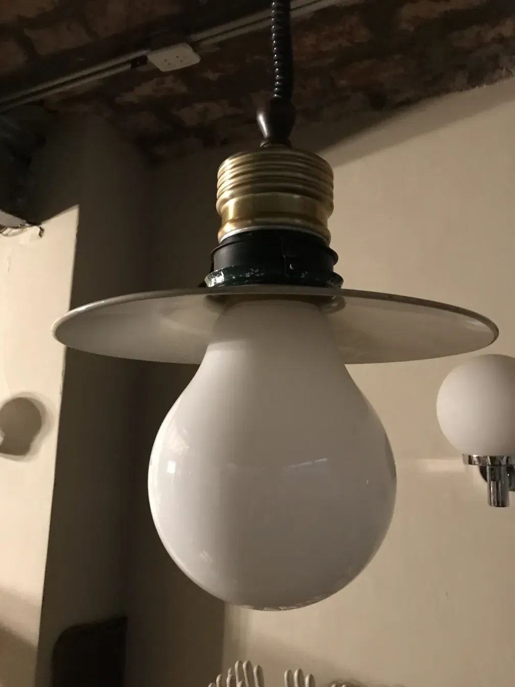 Antique hanging lamp with a spherical shape and elegant base.