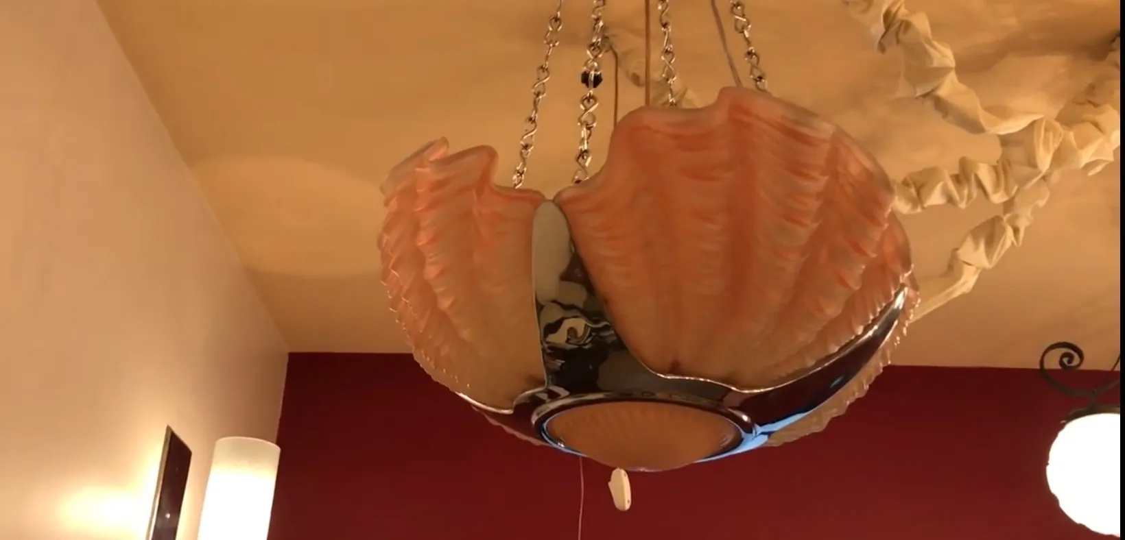 Antique hanging lamp with sea shell design, cozy environment.