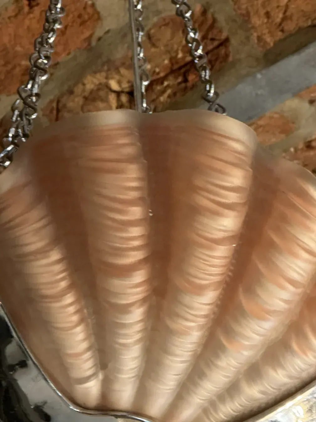 Antique hanging lamp with shell design, warm ambiance.