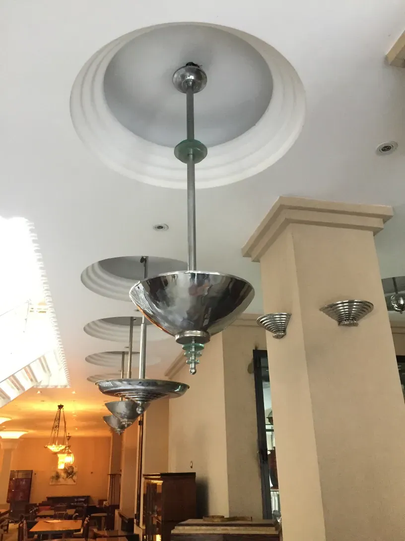 Antique hanging lamp with shiny shades in a well-lit room