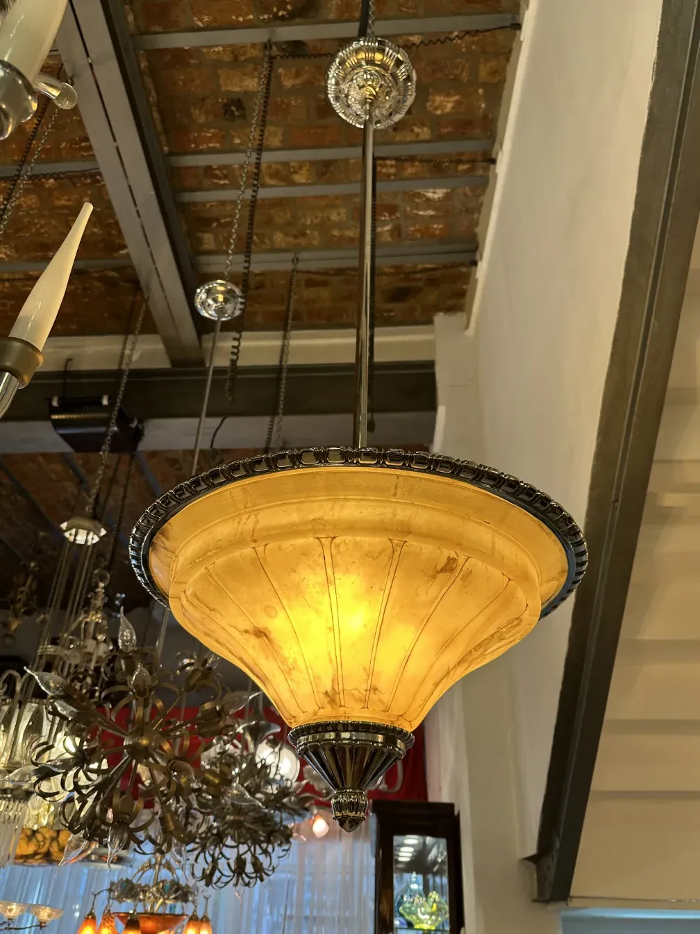 Antique hanging lamp with golden shade and elegant details, cozy ambiance.