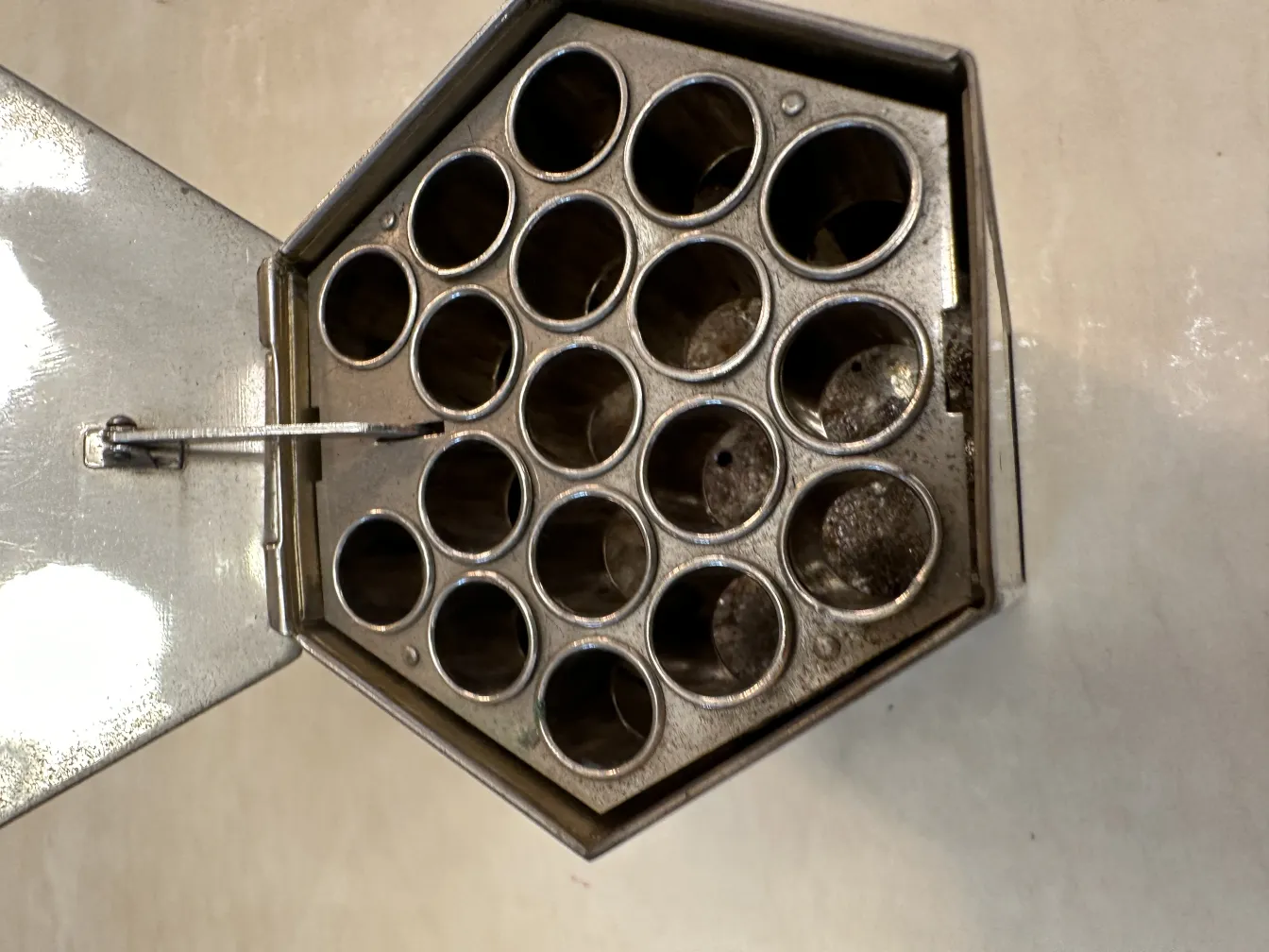 antique box with circular compartments and latch