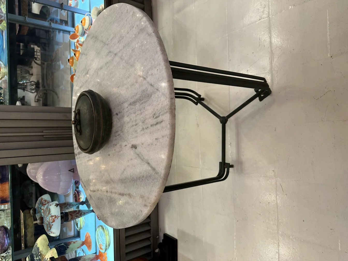 Old box with round design on marble table.