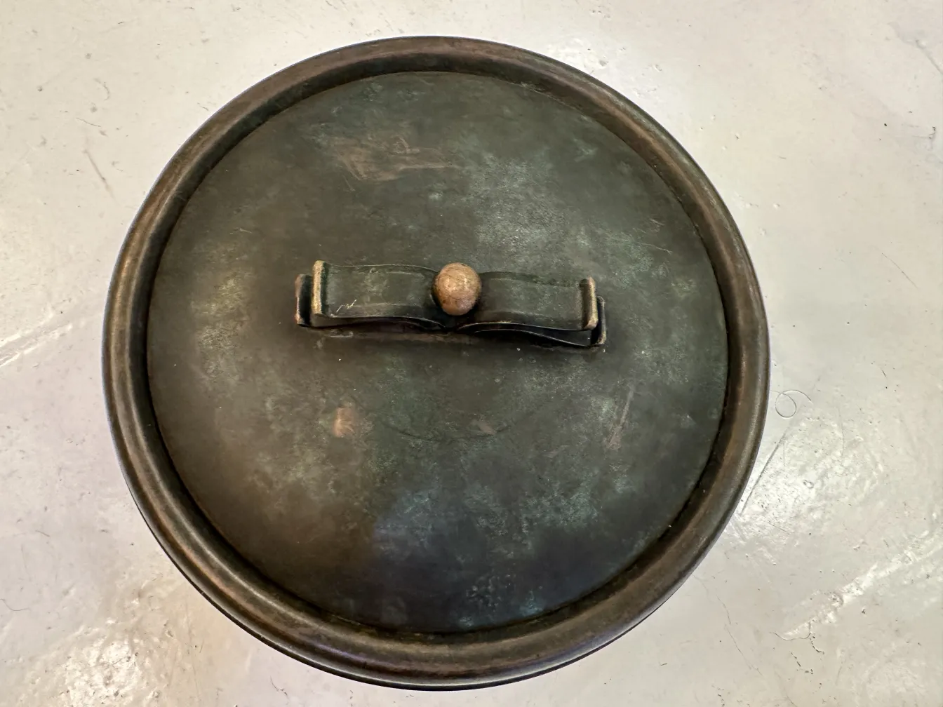 Antique box with lid and visible locking mechanism.