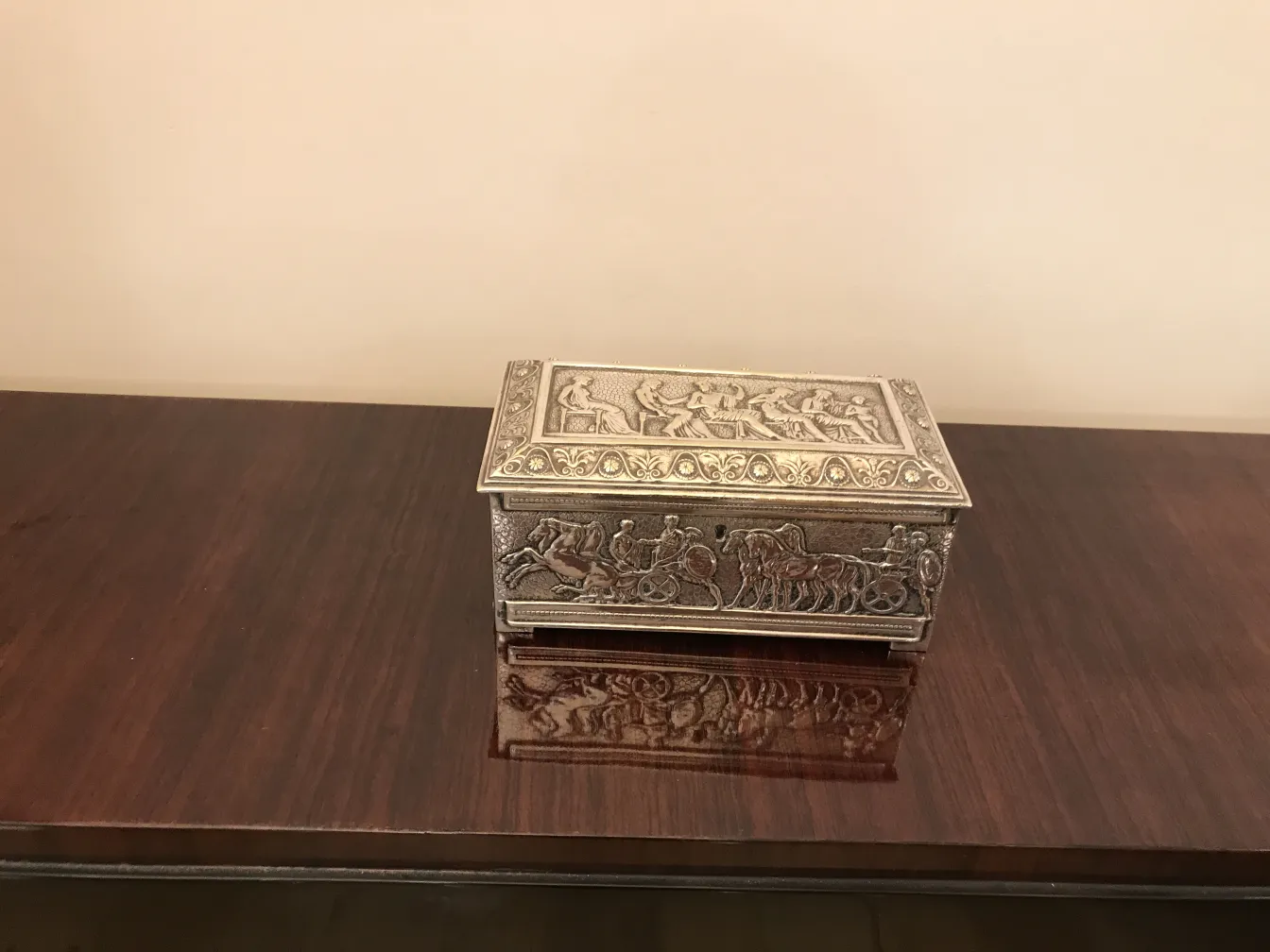 Antique box decorated with reliefs and paintings on the lid