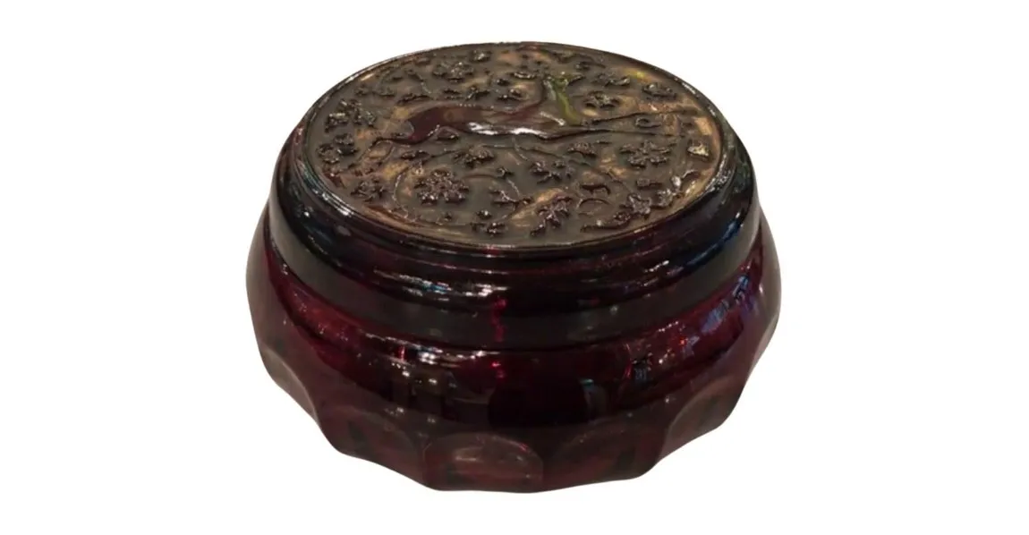 Antique box with floral designs on the lid.