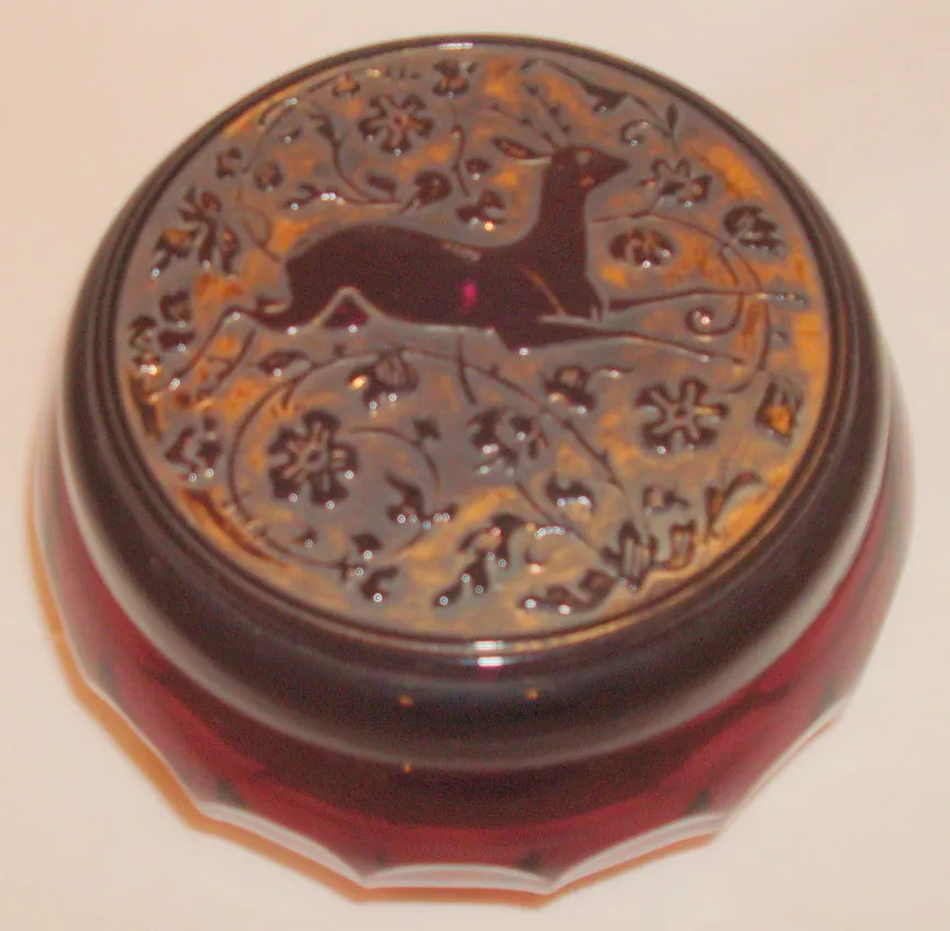 Antique box featuring a dog design on the lid.