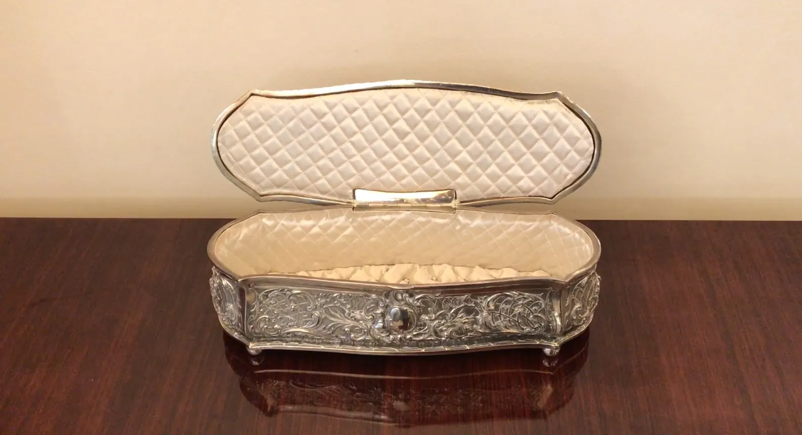 Antique decorative box with intricate design and upholstery