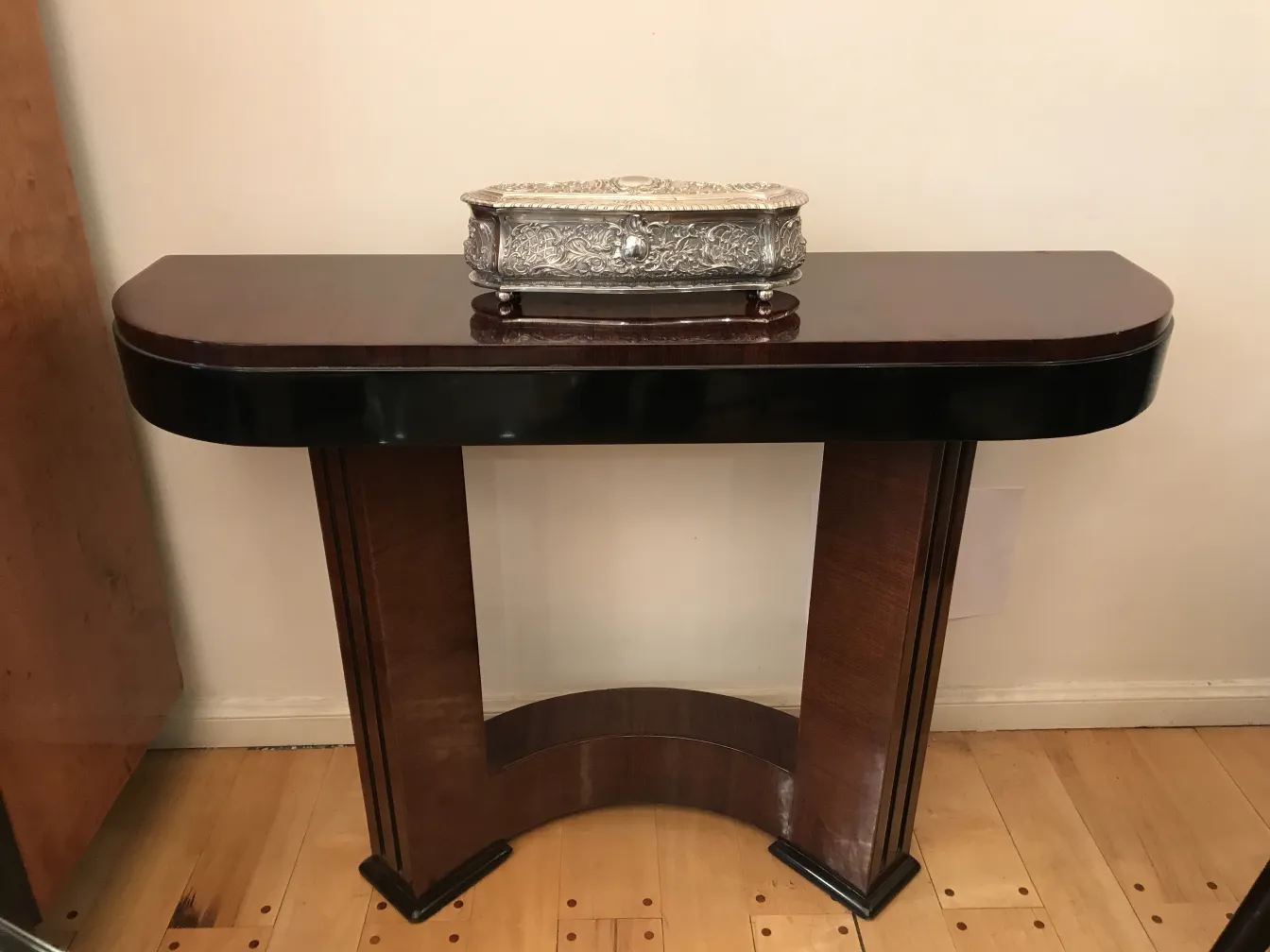 Beautiful decorative antique box on a wooden console.