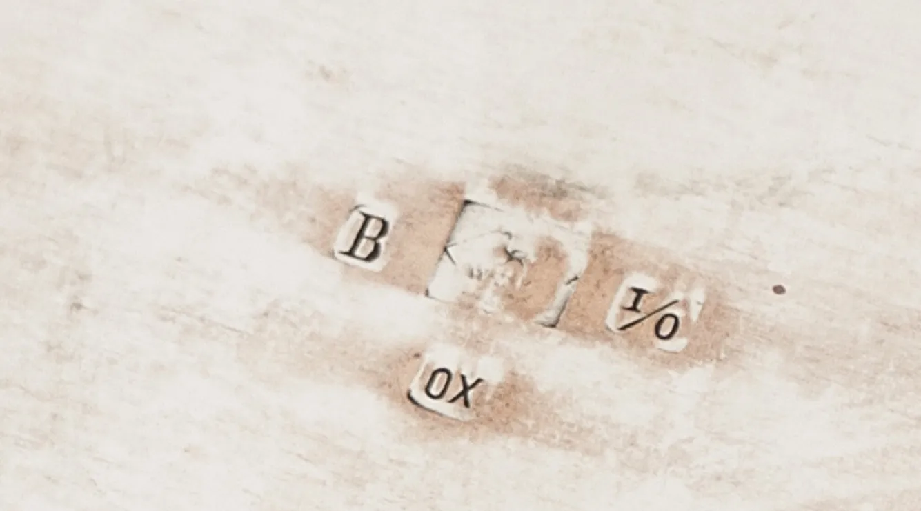 Antique box featuring visible inscription on top.