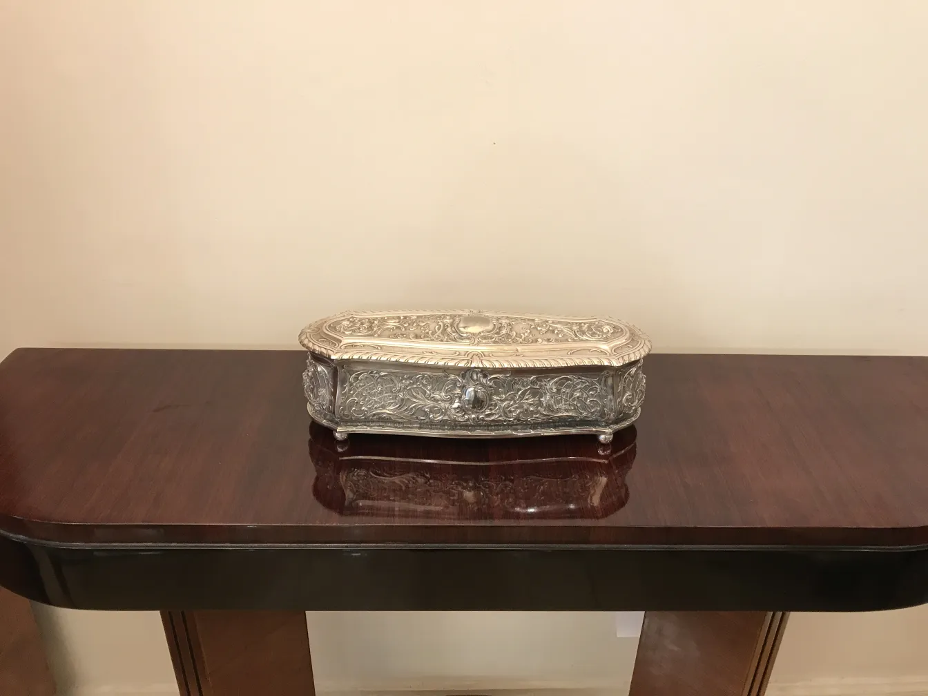 Antique box with intricate design on wooden table