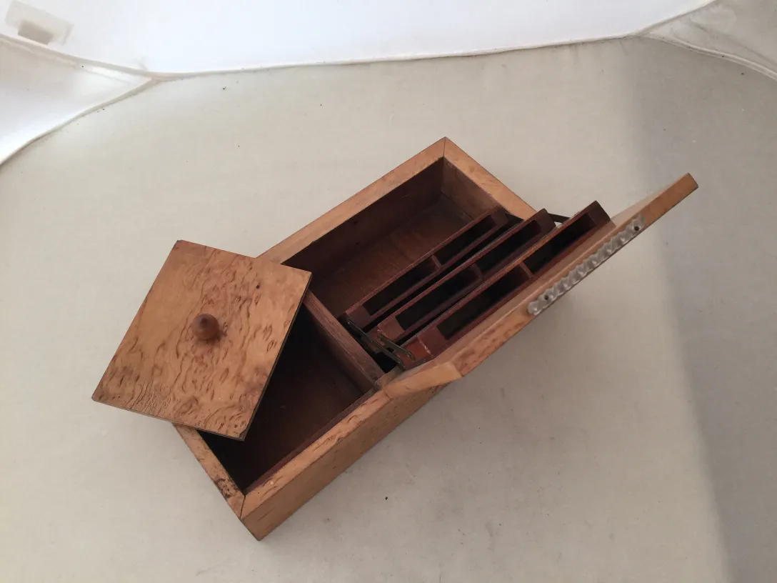 Antique wooden box with internal compartments.