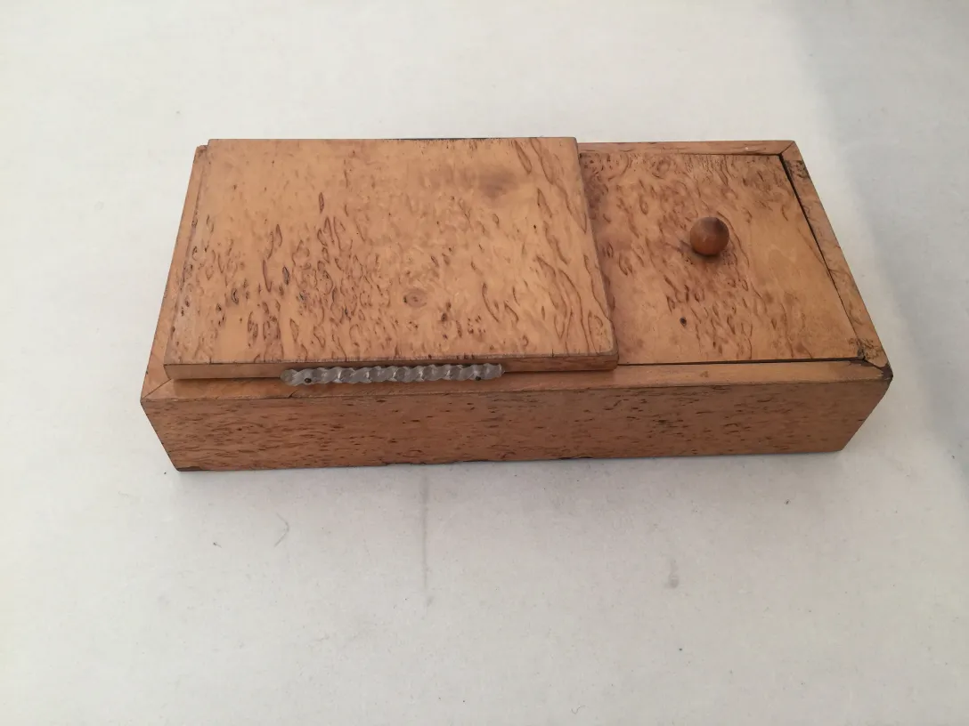 Antique wooden box with dual lid and natural design.